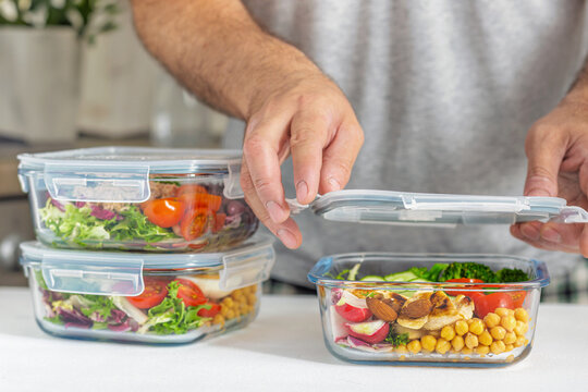 Man preparing healthy meal prep glass containers