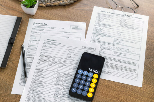 Tax forms with phone calculator and glasses
