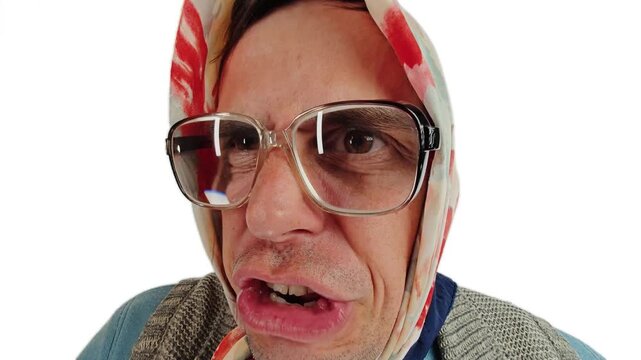 Cross dressing actor as an angry old grandmother shouting and arguing loudly