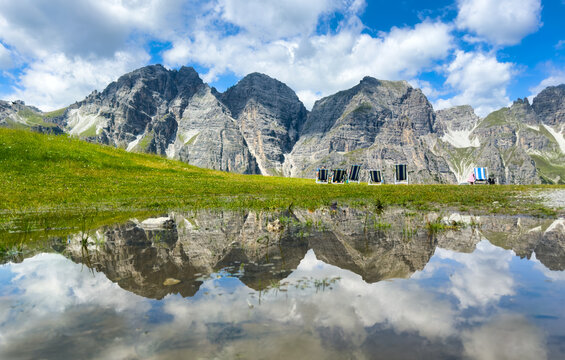 Mountain panorama with reflection in water of the Schlick Mountains with Kalkkogel on the Kreuzjoch near Fulpmes
