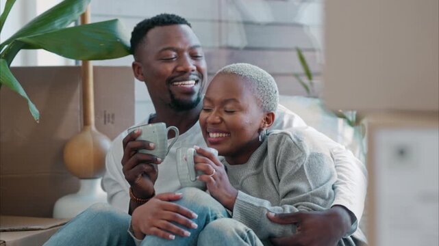New home, coffee and black couple about moving into a house together with husband relaxing and talking with wife. Proud black woman with her lovely African partner before packing the furniture boxes
