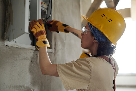 Electrician working on electric meter at construction site