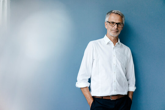 Portrait of a confident businessman with hands in pockets