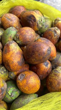 Street vendor selling fresh areca nuts at a busy street market in Dhaka, Bangladesh. Traditional local produce displayed for customers in an everyday market setting