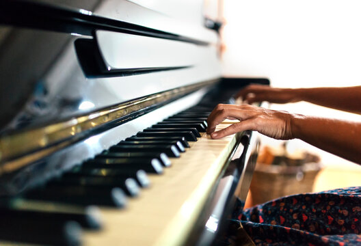 Close-up of woman playing piano
