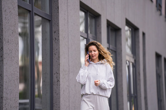 Woman walking in city talking on smartphone