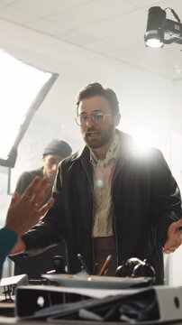 Angry, director or tear with script in filming studio for wrong character, bad acting or production. Frustrated man, producer or flare with actor for poor performance, mistake or instruction on set