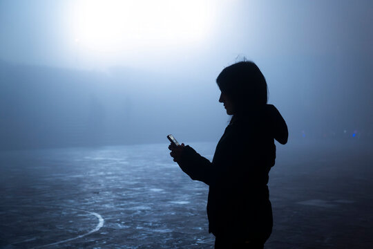 Silhouette using smartphone in foggy ambient Sapa Vietnam