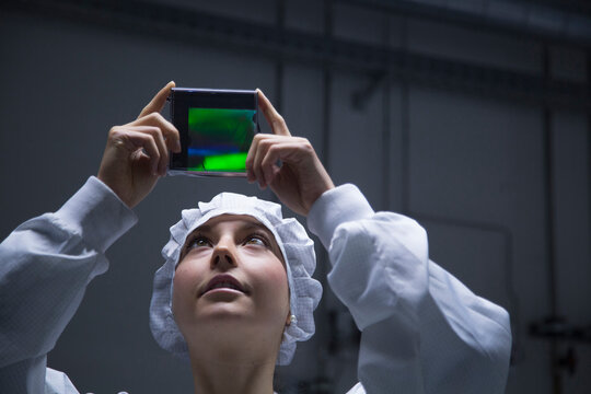 Young female technician looking at holography test in a labroratory