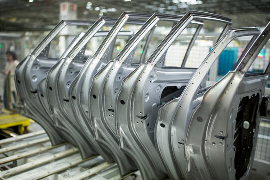 Modern automatized car production in a factory, row of car doors