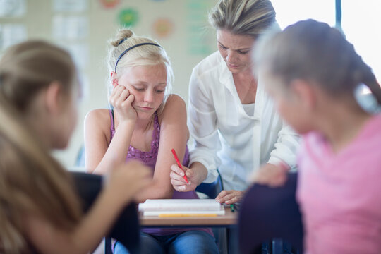 Teacher correcting schoolgirl's bad test