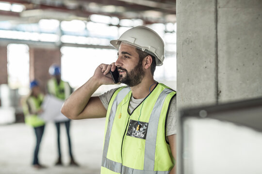 Construction worker on cell phone in construction site