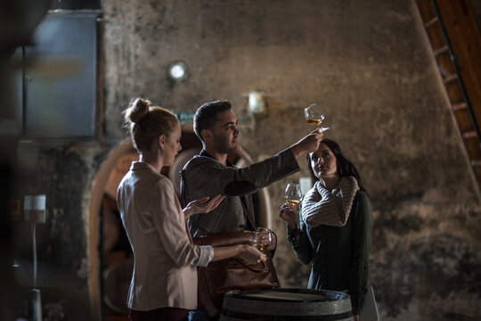 People in distillery tasing whiskey