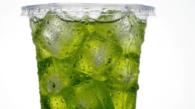 Cold Green Drink with Ice in Plastic Cup