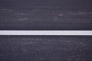Fototapeta premium black asphalt road and white dividing lines, Asphaltic concrete road with yellow and white traffic lines, asphalt, road, surface, traffic, street, transportation, black, white, background, highway, li
