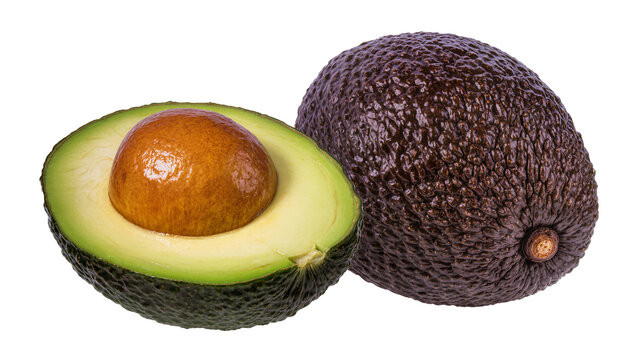 Isolated whole and half ripe avocado fruit with seed, fresh healthy nutritious ingredient