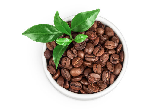Coffee beans in ceramic bowl isolated on a white background. Top view