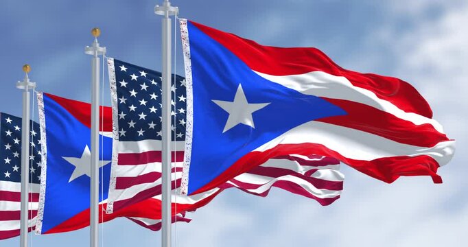 Flags of Puerto Rico waving with the United States flags on a clear day