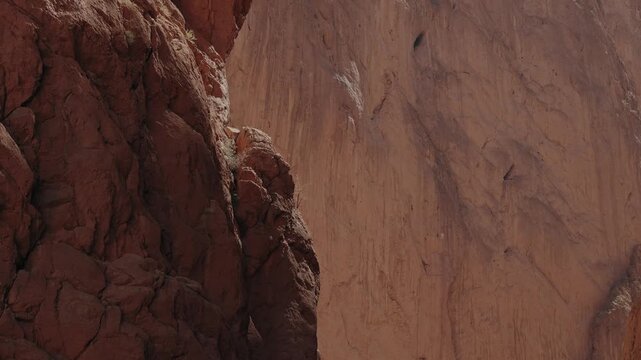 Towering red limestone canyon walls with rugged rock texture at Todgha Gorge in Tinghir Morocco