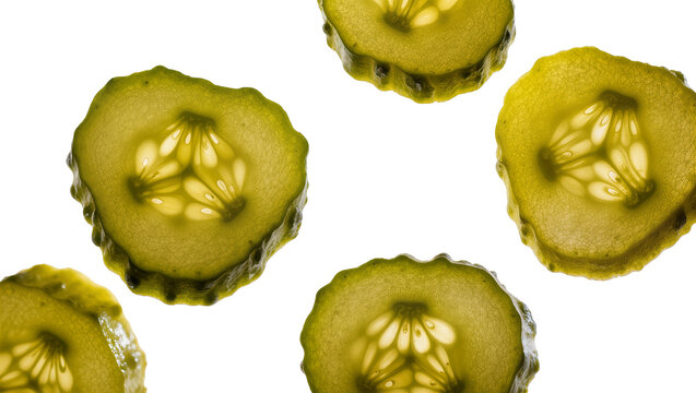 Isolated multiple thin backlit pickle slices showing translucent texture and seeds.
