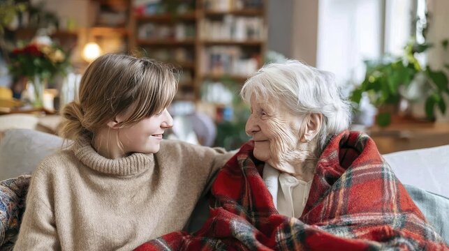 Heartwarming moment: young woman and elderly woman bond at home