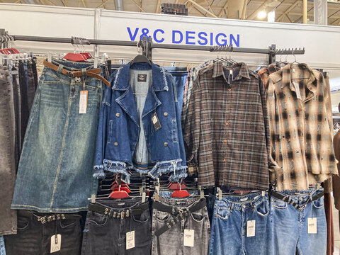 A display of denim jackets, brand VC Design, in a retail store or exhibition, with diverse cuts, distressing, and embellishments Bright lighting highlights the deni - Kyiv, Ukraine 07-31-2025