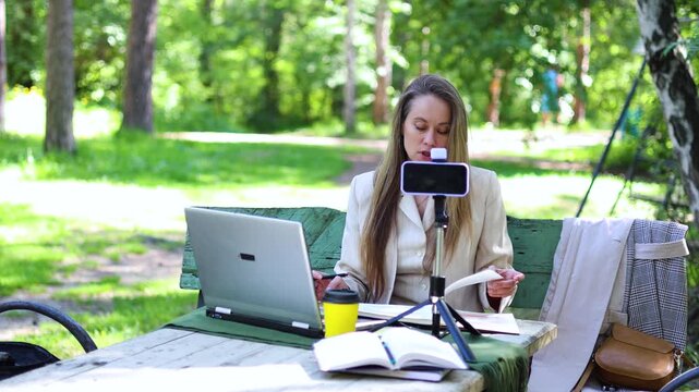 Immerse yourself in nature with an online consultation led by a beautiful woman. The scenic backdrop enhances her engaging discussions, making each moment feel both insightful and special.