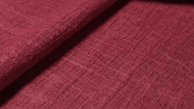 Deep Red Woven Linen Fabric Texture Background with Detailed Rustic Crinkled Surface and Diagonal Shadow