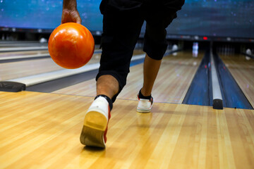 Fototapeta premium Moment before player throws bowling ball to complete his turn. Horizontal format