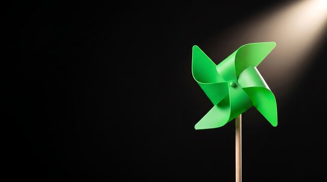 A vibrant green pinwheel toy isolated against a deep black background with soft lighting.