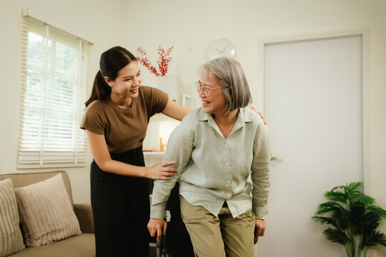 Close-up of a caregiver gently supporting a senior&rsquo;s arm at home, symbolizing compassion, elderly care, assistance, and trust.