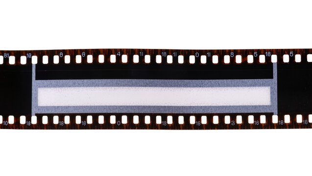 Isolated antique 35mm film strip with sprocket holes and film density test pattern