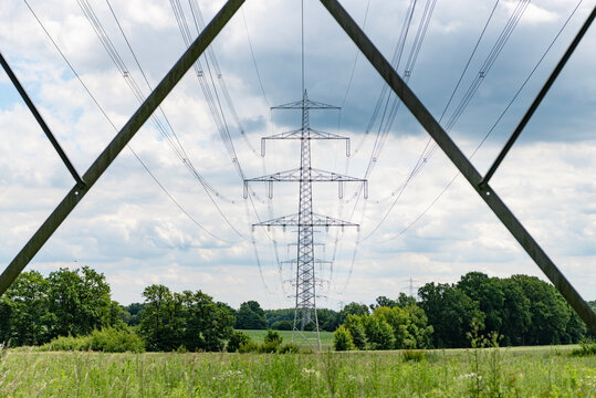 Green nature energy. Landscape of electric voltage station. High voltage. Electricity pylon structure. Nature summer environment. Electricity tower. Electricity power lines in nature landscape