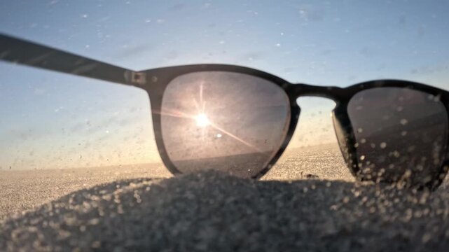 Stylish beach accessories on Kijkduin Beach during a spectacular sunset sandstorm with kiteboarding in the background