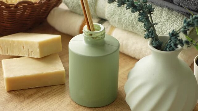 Relaxing spa arrangement with natural soap, diffuser sticks and lavender decoration