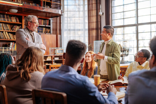 Diverse students participating in university seminar with professor
