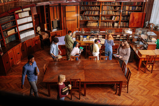 Diverse students studying researching in a university library