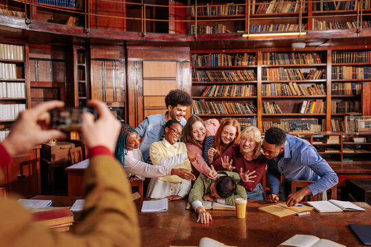 University students playfully posing for a mobile phone