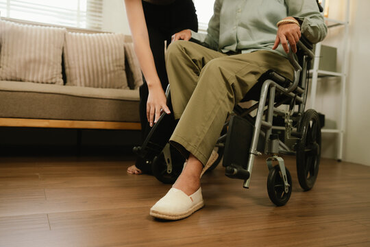 Caregiver assisting a senior in a wheelchair at home, providing mobility support, comfort, and compassionate elderly home care.