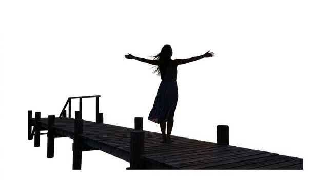 Silhouette of a happy young woman standing with arms outstretched on a wooden pier feeling free and enjoying the day
