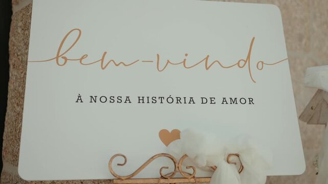 Welcome sign with heart decoration displayed on ornate metal easel