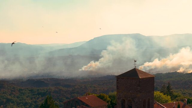 Water Bomber Airplanes Fighting Wildfire with Thick Smoke Behind Village Church Tower