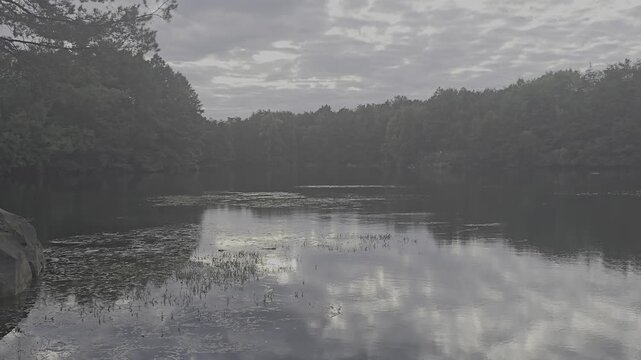 Cinematic 4K slow over scenic lake with bridge and beautiful weat