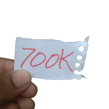 Hand holding a piece of white paper with the text 700k written in red marker isolated on transparent background