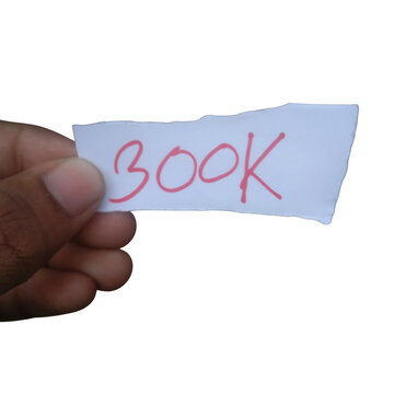 Hand holding a small white paper note with 300k written in red ink isolated on transparent background