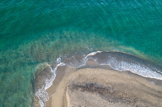 Aerial view of Possidi cape and narrow strip of land wild white sand beach in the Aegean. Sea with turquoise water. Kassandra, Halkidiki, Greece