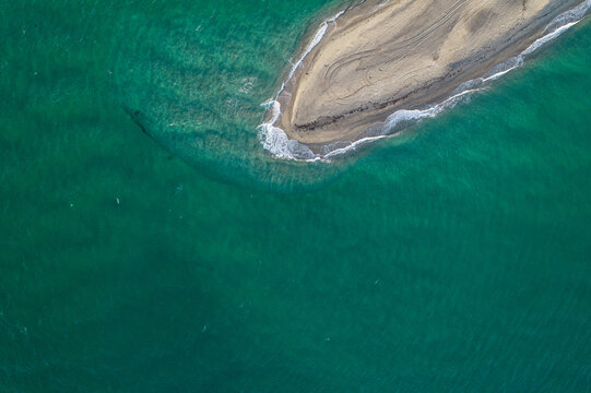 Aerial view of Possidi cape and narrow strip of land wild white sand beach in the Aegean. Sea with turquoise water. Kassandra, Halkidiki, Greece