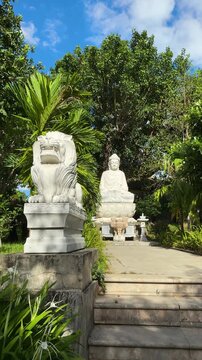 Da nang, lady buddha, buddha statue and foo dog guardian lion sculpture in a serene jungle garden, representing peace, wisdom, and protection