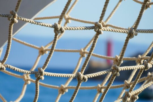 Big net from the boat tide up in harbor with panoramic city view, nautical summer background