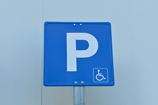 A road information sign indicating a parking lot with designated spaces for disabled people, photographed in Spain.July 18, 2026